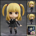 Misa Amane DEATH NOTE chibi action figure with blonde twin-tails, gothic black outfit, Death Note notebook, interchangeable parts, and clear display base.