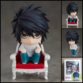 L DEATH NOTE chibi action figure with messy black hair, white shirt, blue jeans, signature crouched pose, chair, dessert accessories, and clear display base.