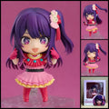 Ai Hoshino OSHI NO KO chibi action figure with purple hair, starry eyes, colourful idol costume, microphone, interchangeable parts, and clear display base.