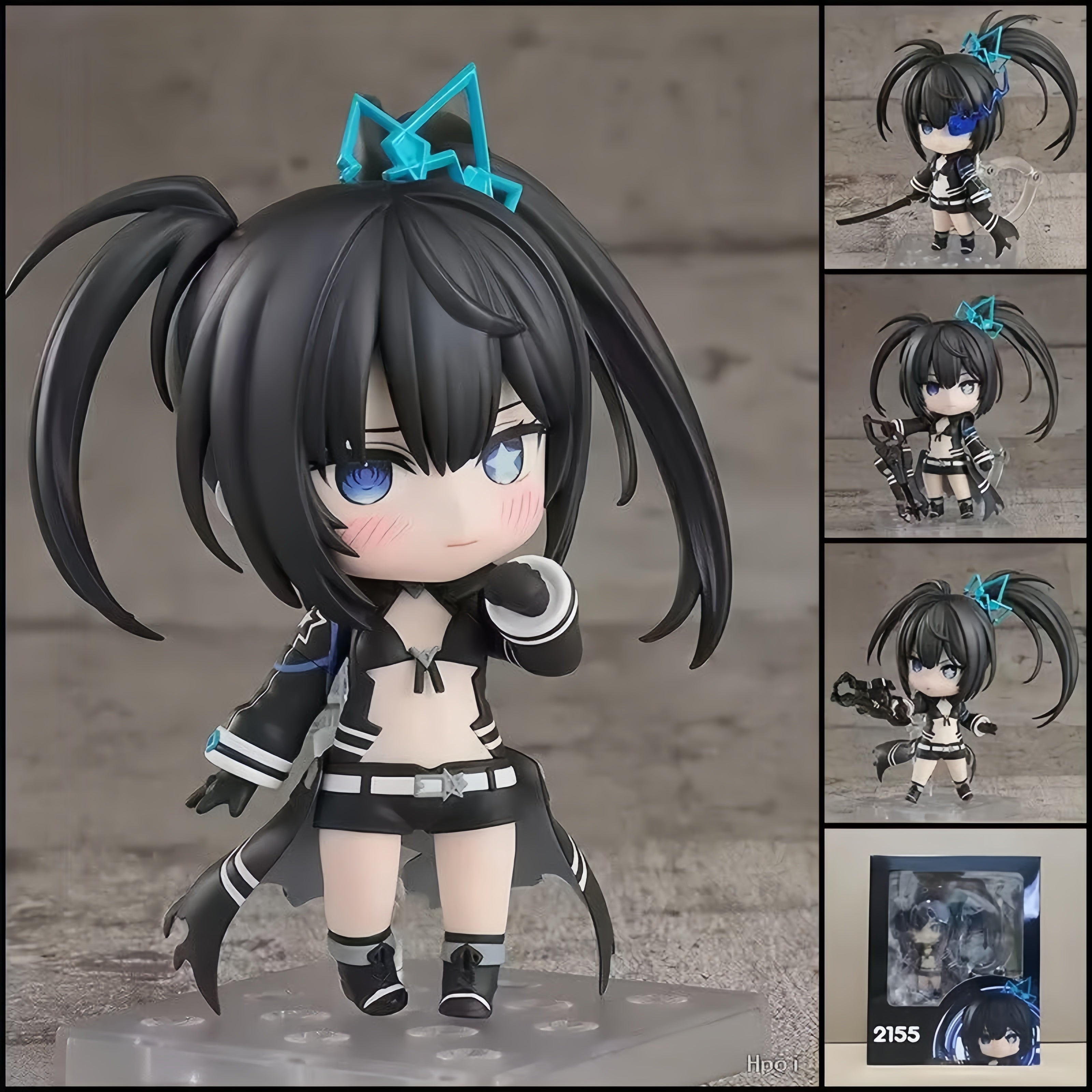 Black★Rock Shooter chibi action figure with black twin-tails, blue flame eye effect, Black Blade, Rock Cannon, interchangeable parts, and clear display base.