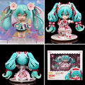 Hatsune Miku 15th Anniversary chibi action figure with turquoise twin-tails, anniversary costume, floral details, character-themed accessories, and decorative display base.