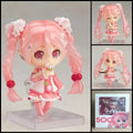Sakura Miku HATSUNE MIKU chibi action figure with long pink twin-tails, cherry blossom-inspired details, pastel outfit, character-themed accessories, and clear display base.