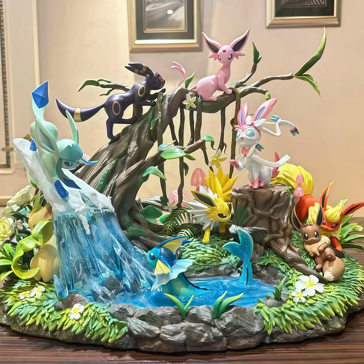 Pokémon Eevee and Eeveelutions 27 cm GK diorama featuring Vaporeon, Jolteon, Flareon, Espeon, Umbreon, Leafeon, Glaceon and Sylveon in a forest waterfall display.